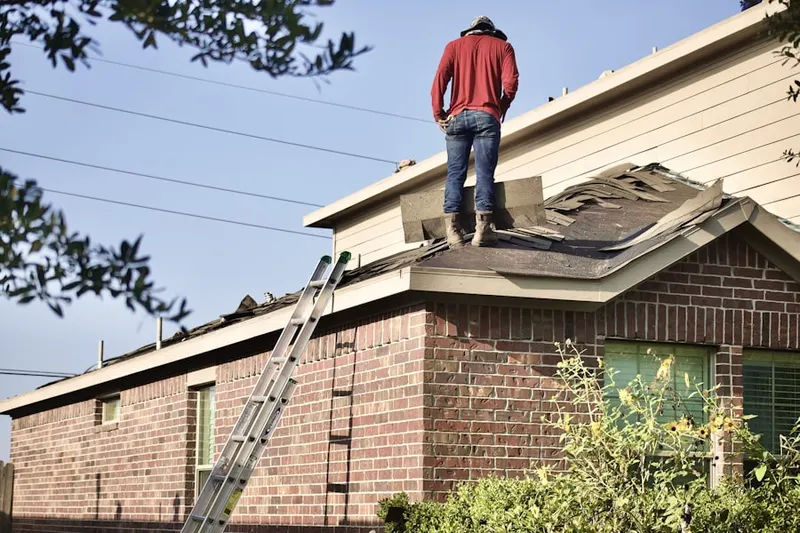 Professional roofer working on a residential roof in Country Villa Estates